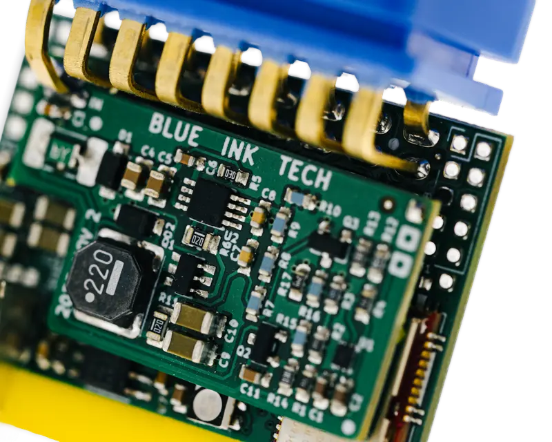 A BIT board with gold spring contacts and Blue Ink Tech printed on it